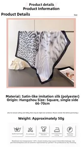 Detail view of animal print silk scarf featuring leopard and zebra patterns on black satin
