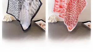 Detail of silk satin scarves featuring leopard, tiger and zebra animal print patterns