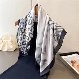 Elegant animal print scarf featuring zebra and leopard patchwork design in silk-like fabric