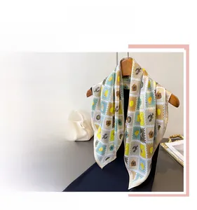 Detail of artistic stamp print silk scarf showing colorful vintage square patterns