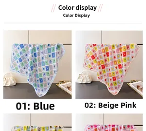 Detail view of printed silk scarves featuring creative stamp patterns in blue and beige