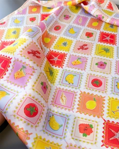 Close-up of vibrant summer stamp print silk scarf with smooth satin fabric texture