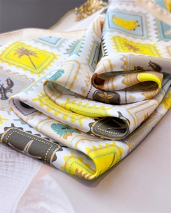 Close-up of tropical palm and lobster print on soft silk square scarf with rolled edges