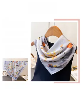 Close-up of elegant lavender floral silk scarf with vibrant orange flower print