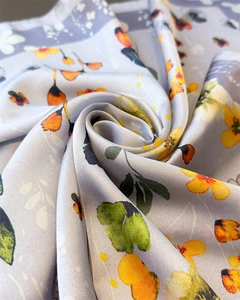 Macro detail of lavender floral silk scarf showcasing smooth texture and glossy finish