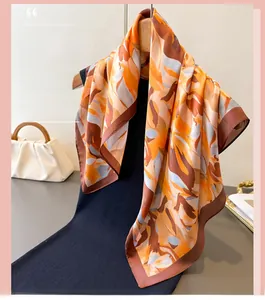 Close-up of abstract oil painting style silk scarf with orange and blue floral print
