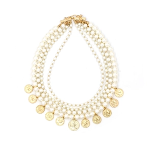 Five-layer faux pearl necklace featuring vintage gold coin pendants on white background