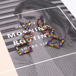 Long colorful rhinestone geometric drop earrings with gold finish and vibrant crystals