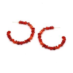 Detail of red stone beads and gold studs on Bohemian C-shaped hoop earrings