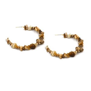 Macro detail of Bohemian C-shape hoop earrings with natural brown stone beads on gold wire