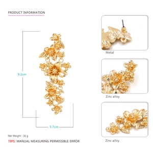 Detail view of large gold floral earrings with measurements of 9.2cm height and 3.7cm width