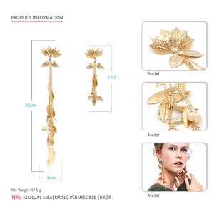 Long gold metal leaf tassel earrings with asymmetric leaf drop pendants and fringe style