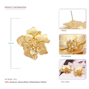 Vintage oversized gold flower stud earrings with rhinestones and textured petals