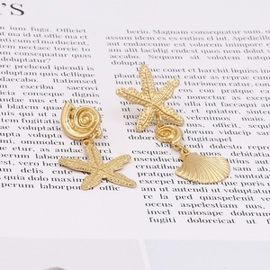 Golden asymmetrical ocean-themed starfish and seashell drop earrings with textured finish