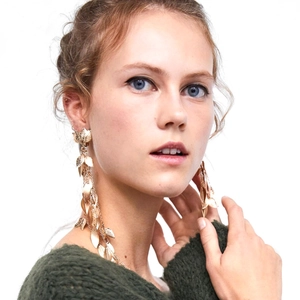 Elegant gold metal leaf tassel earrings featuring a long asymmetrical fringe design