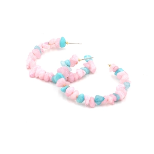 Detail of bohemian C-shape hoop earrings with pink and blue crushed stone beads