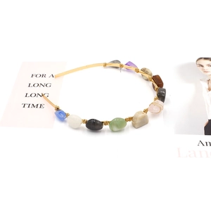 Handmade beaded headband with colorful irregular stones on a gold-plated wire frame