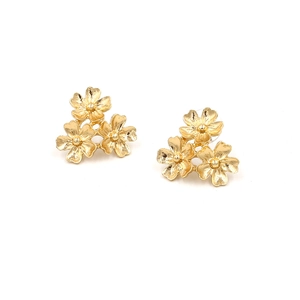 Macro detail of golden triple flower stud earrings with brushed metallic texture petals
