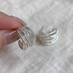 Silver multi-layered twisted C-shaped hoop earrings with vintage textured metal wire design
