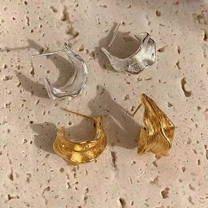Chic silver and gold irregular pleated hoop earrings with a lava texture finish