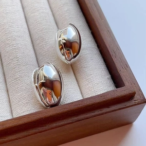 Polished silver tulip bud earrings in a premium wooden jewelry box display