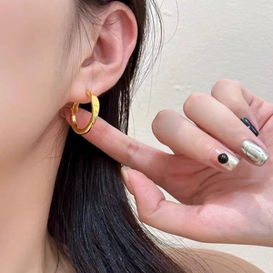 Minimalistische polierte goldene Creolen für Damen mit modernem metallischem Glanz