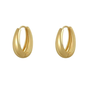 Polished gold chunky hoop earrings with a minimalist oval design on white background