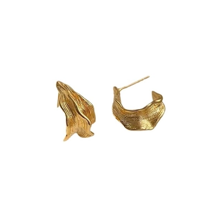 Irregular textured gold geometric C-shaped earrings with artistic organic wave design