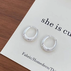Elegant S925 silver croissant hoop earrings with twisted metal texture on a card