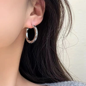 Minimalist silver multilayered textured hoop earrings with a modern stacked metal design