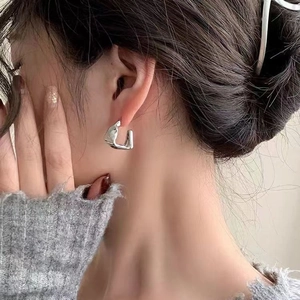 Chic silver irregular geometric lava style hoop earrings for a modern metallic fashion look