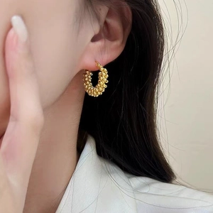 Fashionable golden textured bead hoop earrings for women in a vintage minimalist design