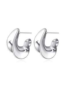 Close-up of polished metal spiral earrings with a minimalist double-curved geometric design