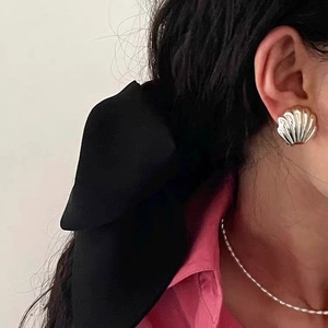 Elegant French vintage shell earrings in gold finish worn by model with jewelry