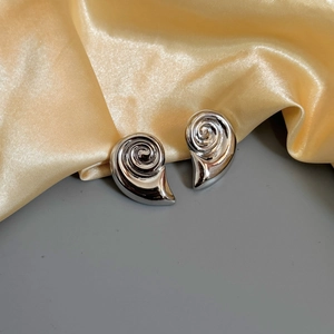 Polished silver geometric spiral snail earrings on elegant satin backdrop