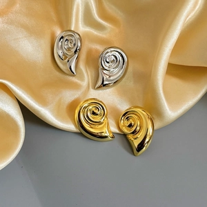 18K gold and silver geometric spiral snail earrings with polished mirror finish texture
