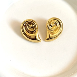 Macro shot of 18K gold plated spiral earrings with a polished nautilus geometry design
