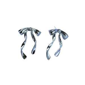 Minimalist silver butterfly bow earrings with fluid ribbon design and polished finish