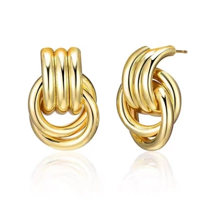 Detailed macro view of 18K gold plated multi-layer twisted hoop earrings in metal style
