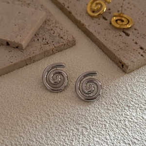 Minimalist spiral ear studs in gold and silver finish with polished metallic texture