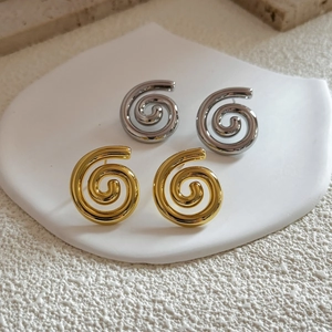 18K gold plated minimalist spiral hoop earrings set in polished gold and silver finishes