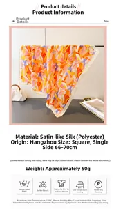 Close-up of silk-like satin square scarf with abstract orange and purple floral print