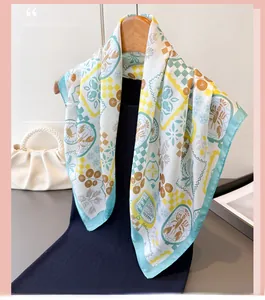 Detail of floral silk scarf with crab pattern on a wooden hanger with pearl bag
