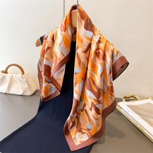 Satin neck scarf with abstract orange and brown floral print and elegant dark borders