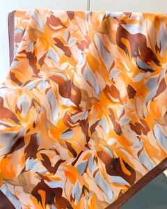 Close-up of abstract artistic print silk scarf with glossy satin texture and neat edges