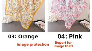 Detail of silk-feel scarves with tropical palm and shell prints in orange and pink
