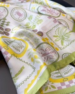 Detail of printed silk scarf featuring sardine and lobster patterns with silky texture