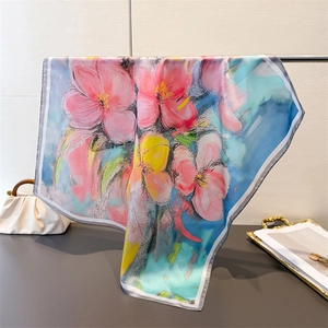 Détail d'un foulard carré en soie avec imprimé floral artistique suspendu avec élégance