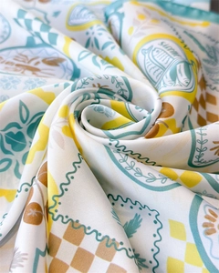 Detailed shot of Mediterranean silk scarf with vibrant sardine and lemon prints