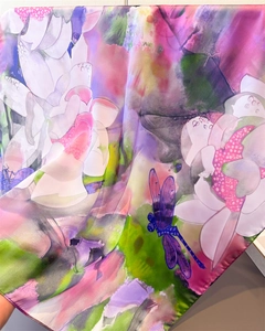 Detailed view of silk-like scarf featuring pink lotus petals and purple dragonfly prints